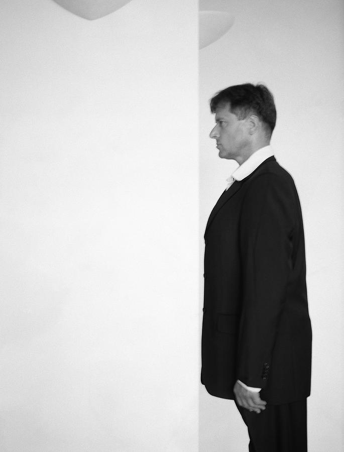 Man facing wall, slightly blurred, b&w. Photograph by Matthieu Spohn