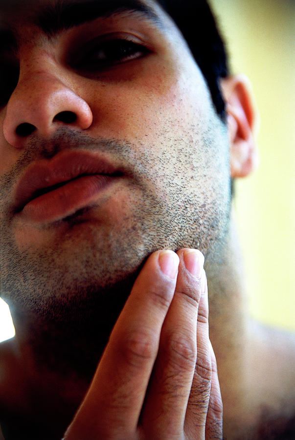 Man Feeling Stubble Photograph by Tracy Rutter/science Photo Library