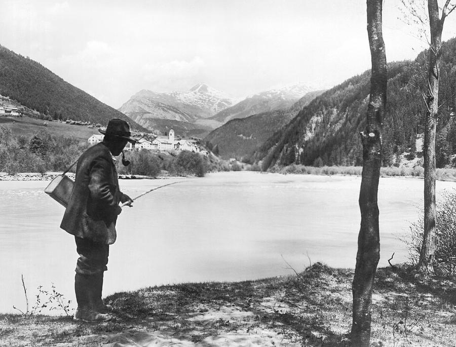 Man Fishing In Switzerland Photograph by Underwood Archives