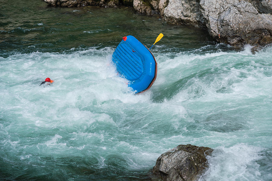 Man floating in a river after his raft flipped over while white water river rafting Photograph by Tdub303