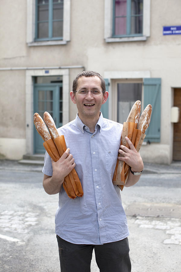Man holding baguette Photograph by Muriel de Seze