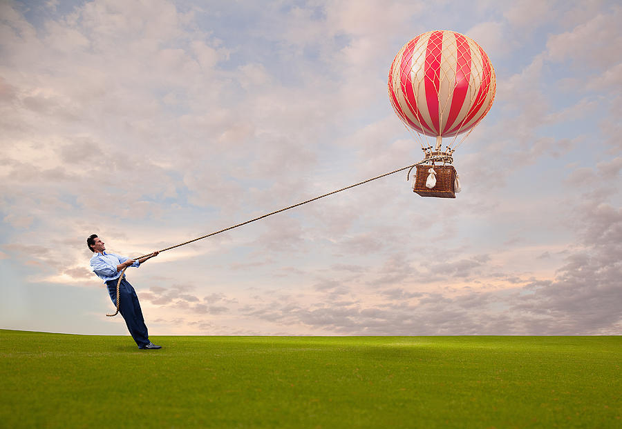Man holding hot air balloon Photograph by PM Images