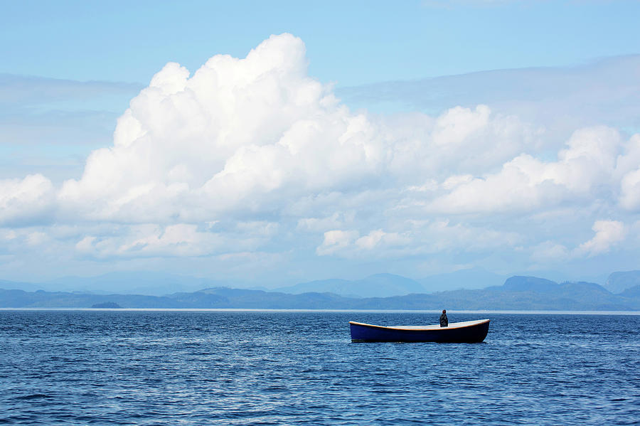 Man In Boat Adrift Photograph by Grant Faint - Fine Art America