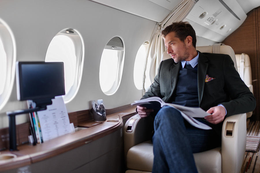 Man in private jet airplane Photograph by Extreme-photographer