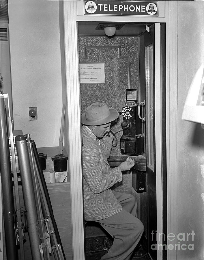 Man Photograph - Man in Telephone booth circa 1955 by Monterey County Historical Society