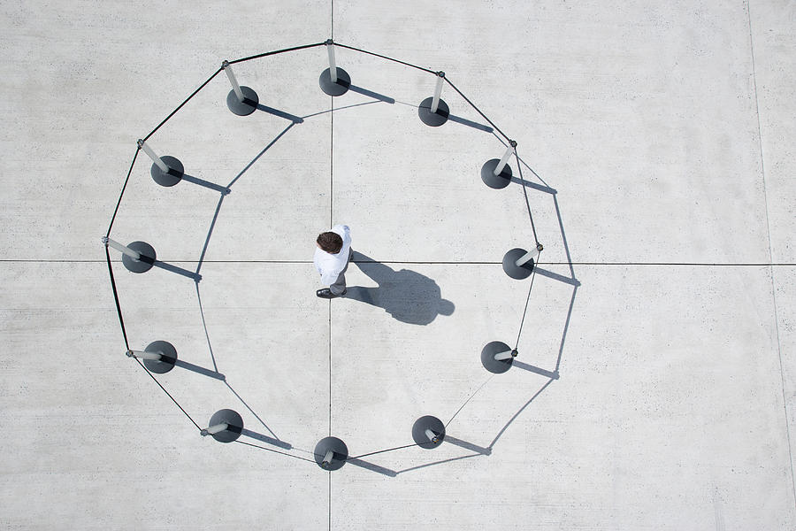 Man inside circle of cordon posts Photograph by Martin Barraud