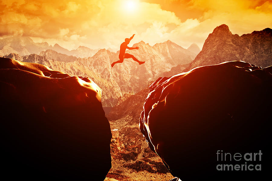 Sunset Photograph - Man jumping over precipice in mountains by Michal Bednarek