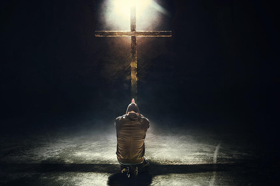 Man Kneeling Before the Cross Photograph by RyanJLane