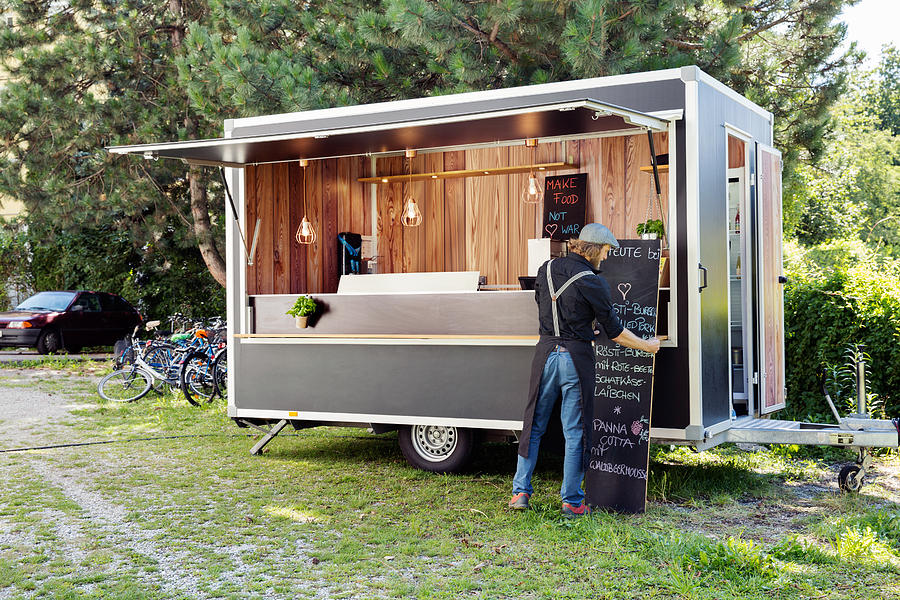 Man opening food truck for business, Innsbruck Tirol, Austria Photograph by Manuela