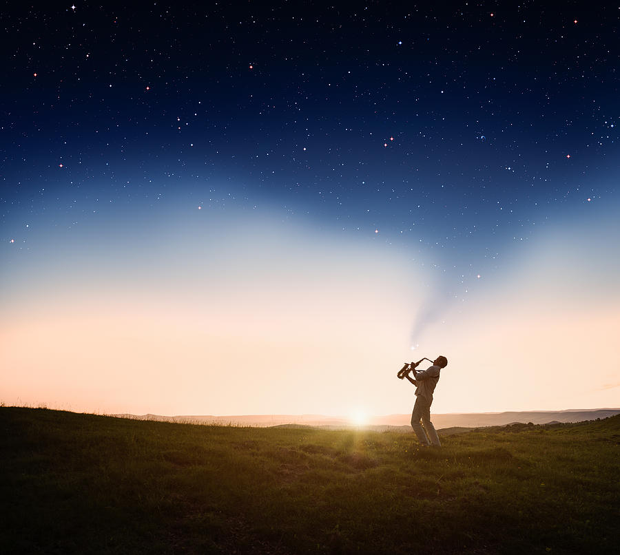 Man playing a saxophone at sunset Photograph by AlexSava