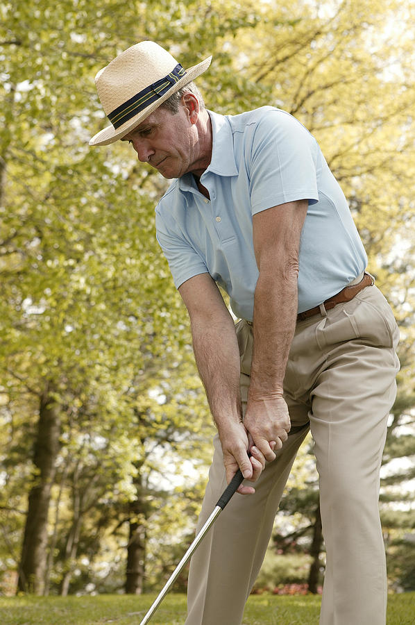 Man playing golf Photograph by Comstock Images