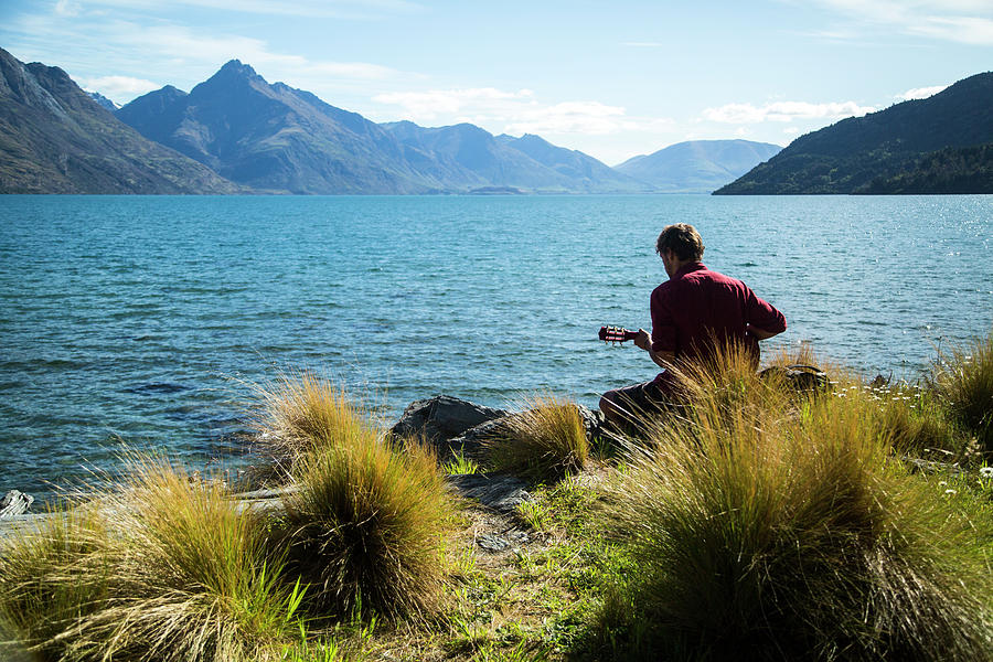 Fiordland National Park Photograph - Man Playing The Guitar Along The Side by Paul Bikis