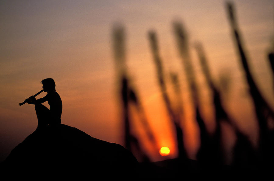 Man Plays Flute At Sunset, Hampi, India Photograph by Corey Rich
