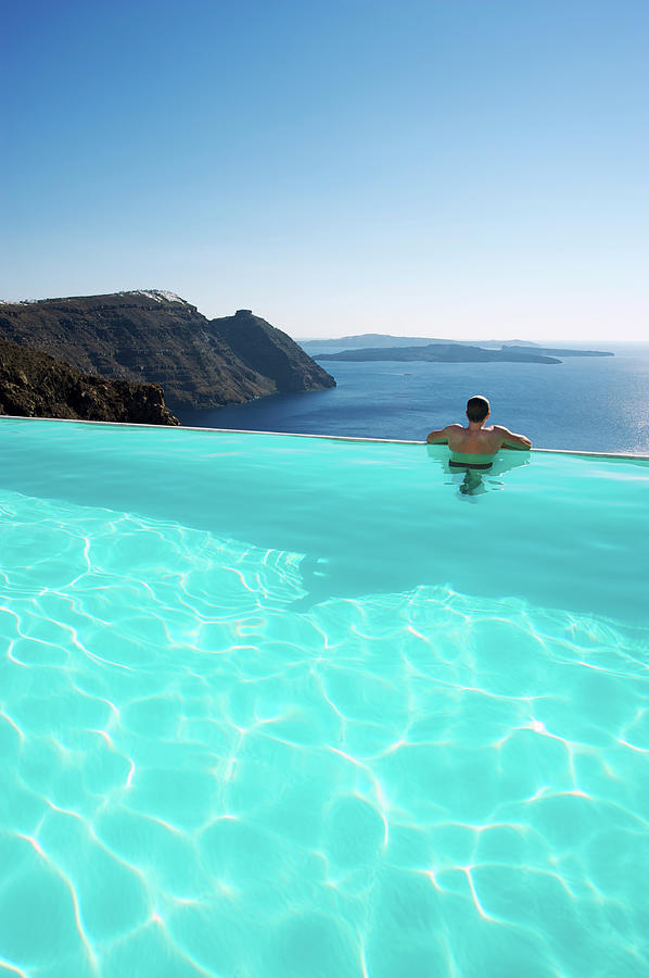 Man Relaxing Looking At Santorini Photograph by Peskymonkey