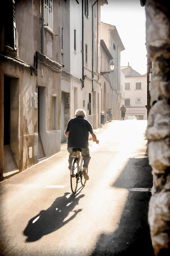 Man riding bicycle in street in Puerto Pollenca Photograph by Neil Alexander Photography