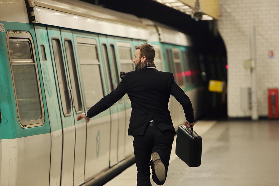 Man running for underground train Photograph by Peter Cade