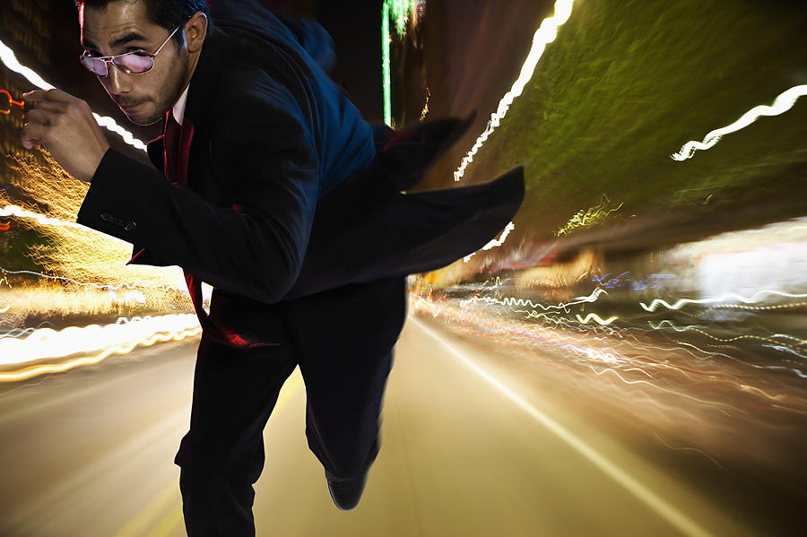 Man running on street at night (Digital Composite) Photograph by Siri Stafford