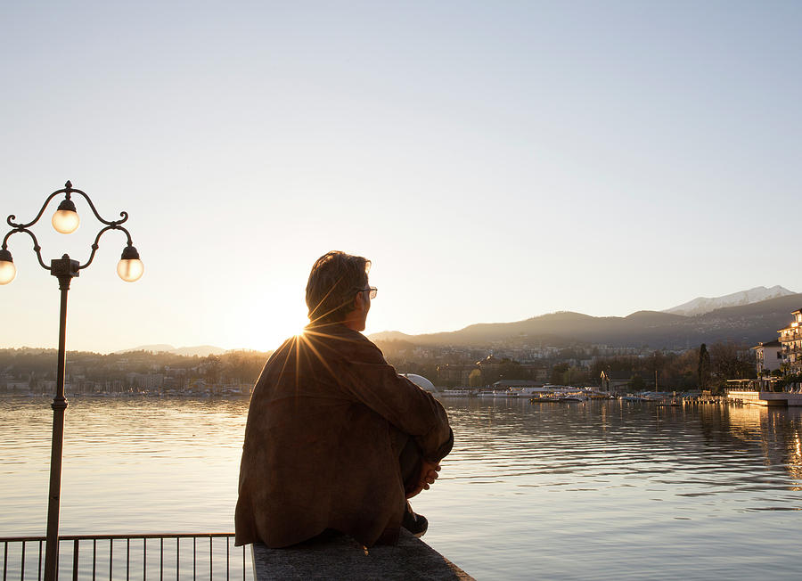 Man Sits In Park At Sunset With Lake Photograph by Philip & Karen Smith ...