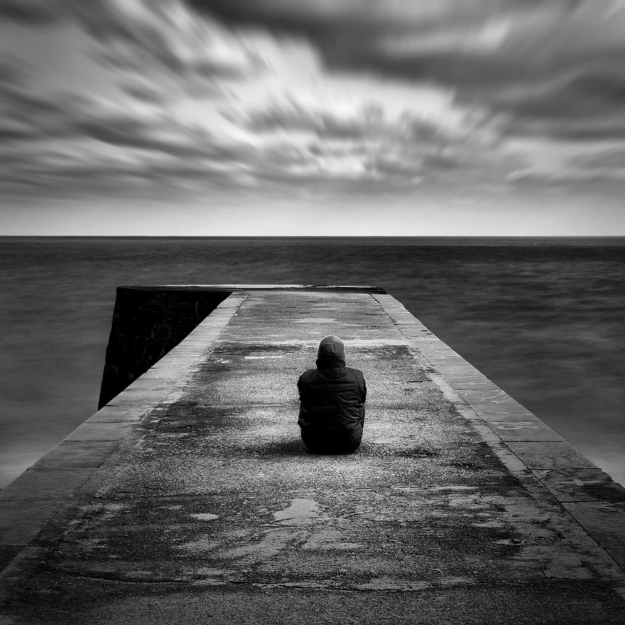 Man Sitting On Jetty Photograph by Miguel Cabezas Centeno