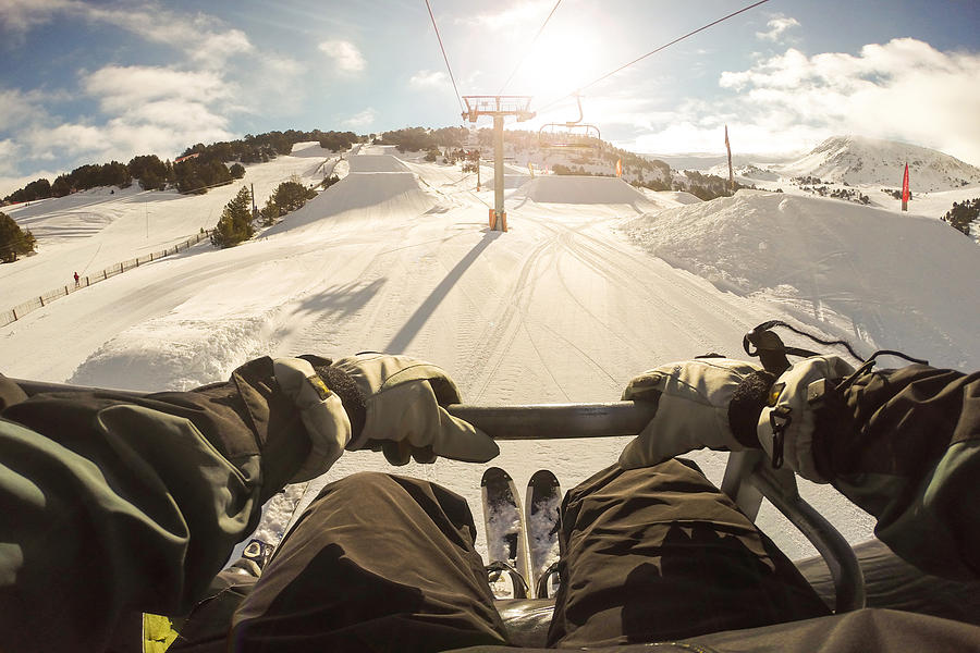 Man sitting on ski lift in the Pyrenees from pov. Photograph by Artur Debat
