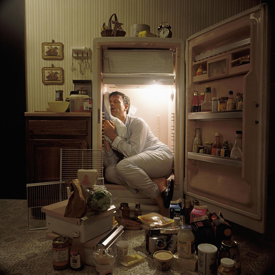 Man sleeping inside refrigerator Photograph by James Porter