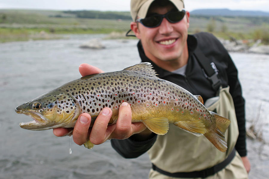 Man Smiles While Holding A Fish Photograph by Jordan Siemens | Fine Art ...