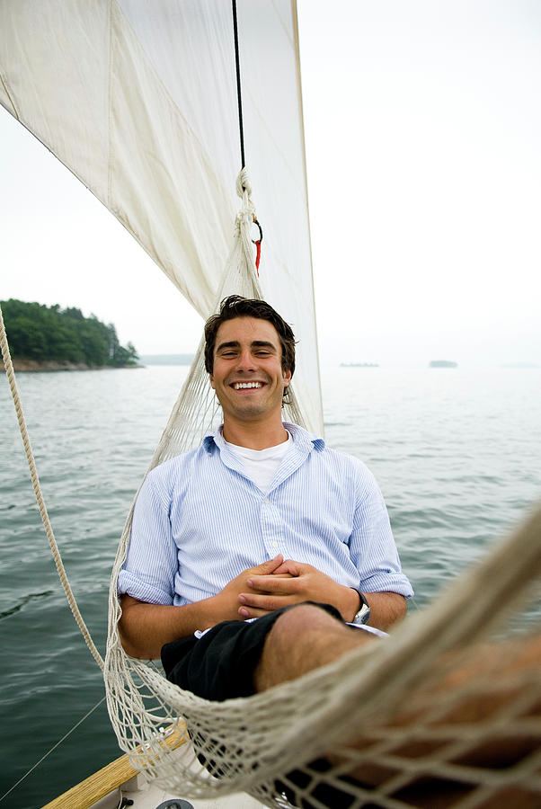 Portland Photograph - Man Smiling On Hammock Onboard by Peter Dennen