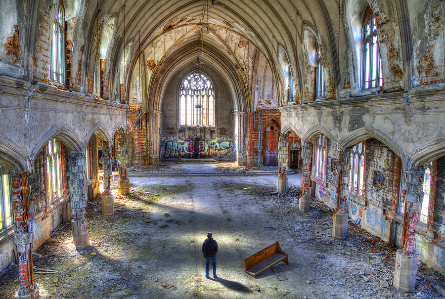 Man standing in abandoned church Photograph by Grant Faint