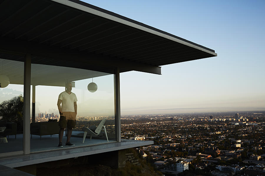 Man Standing In House Overlooking Los Angeles. Photograph by Ballyscanlon