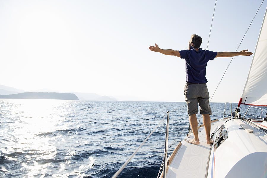Man Stands At Bow Of Yacht With Arms Outstretched Photograph by Gary John Norman