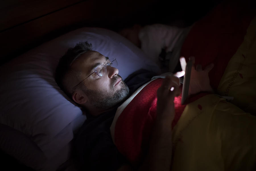 Man using his smart phone in the dark Photograph by Thanasis Zovoilis