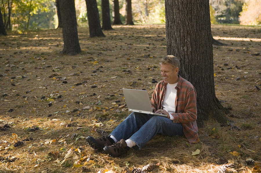Man using laptop outdoor Photograph by Comstock Images
