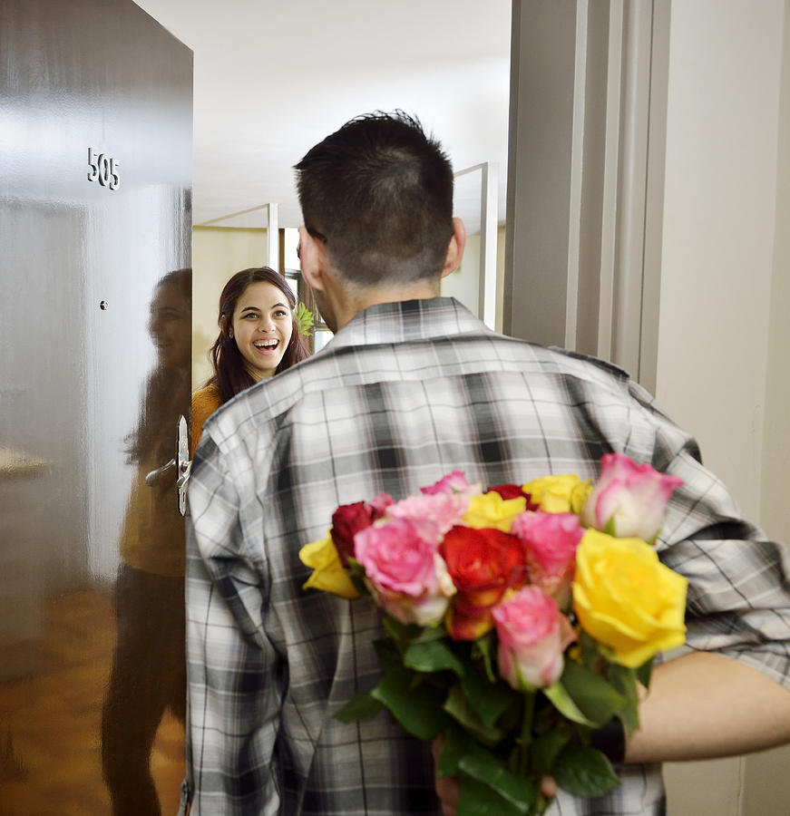 Man visiting his girlfriend bringing flowers. Photograph by David Malan