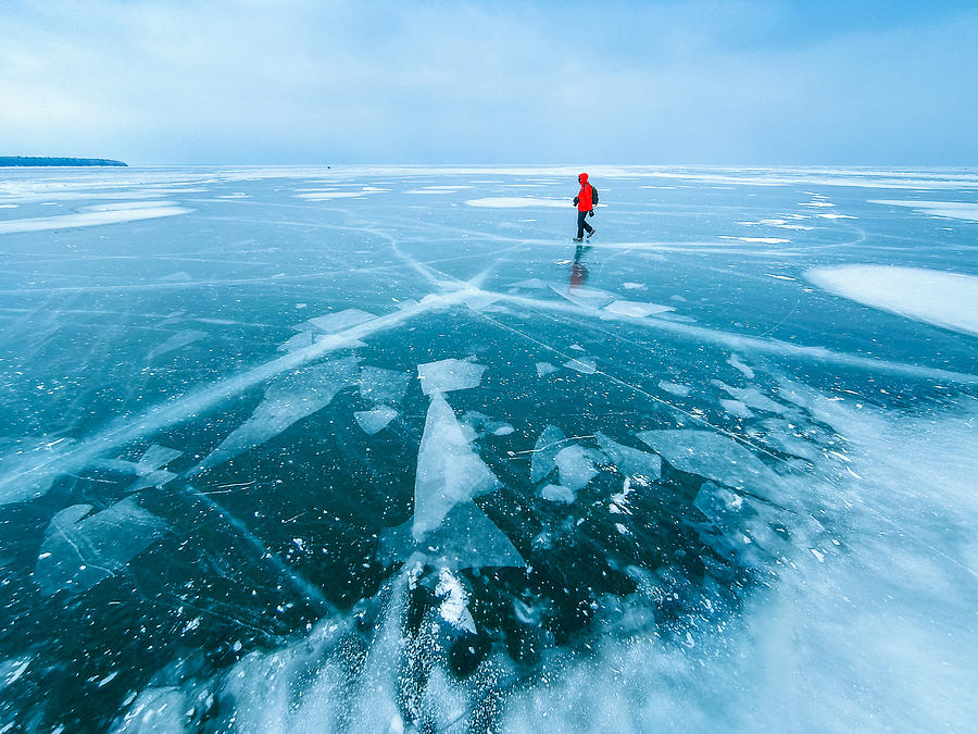 man walking across frozen lake, Apostle Islands, Wisconsin, America, USA Photograph by Darekm101