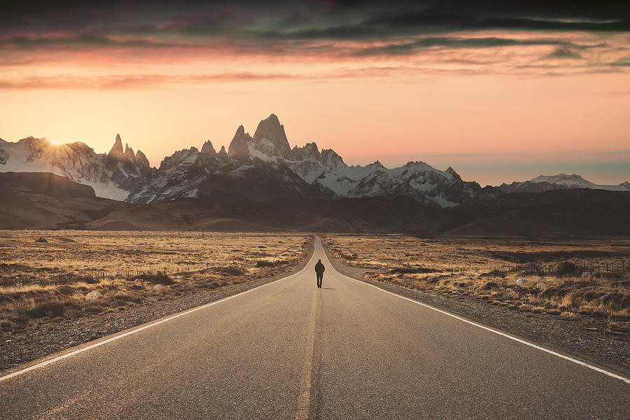 Man walking alone on the road to Fitz Roy, Patagonia Argentina Photograph by © Marco Bottigelli
