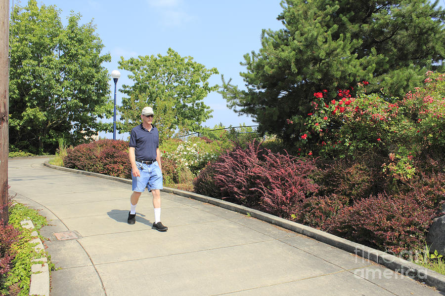 Man walking down sloped sidewalk Photograph by Lee Serenethos - Pixels