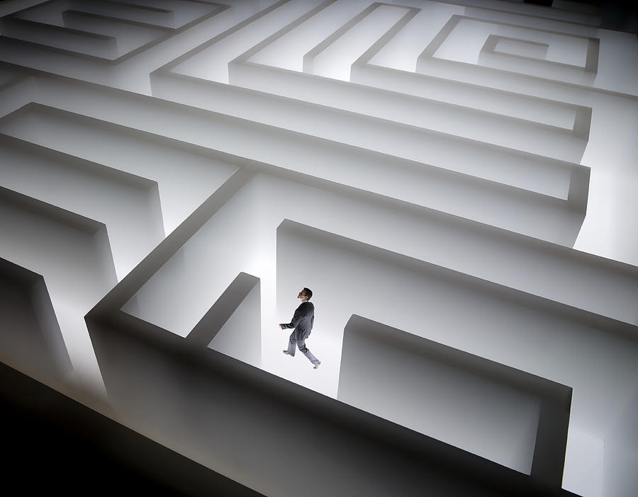 Man walking in giant maze Photograph by Stewart Sutton