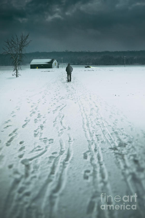Man walking in the distance towards a barn Photograph by Sandra Cunningham