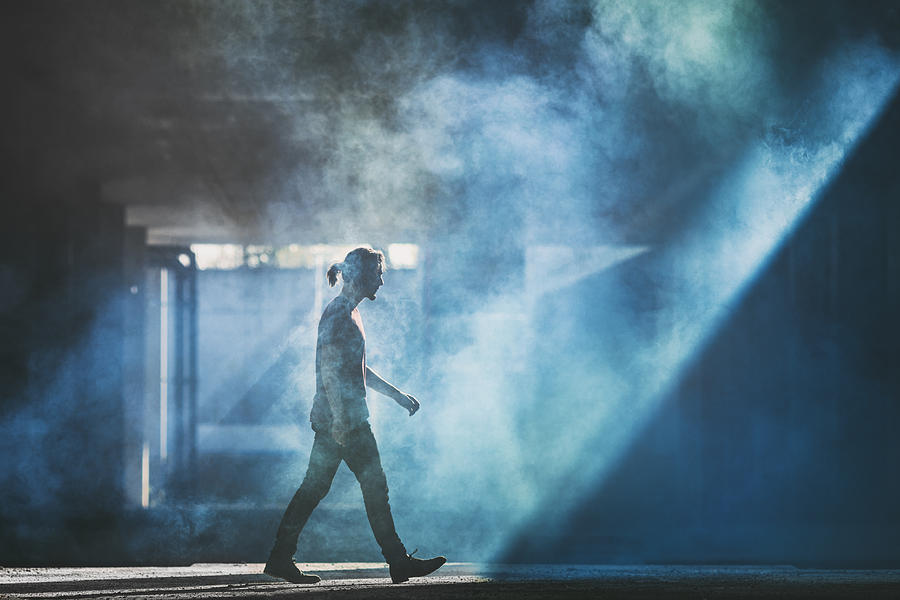 Man walking in the smoke Photograph by Piranka