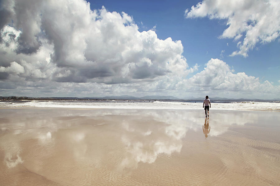 Man Walking On Beach With Clouds Photograph by Jodie Griggs