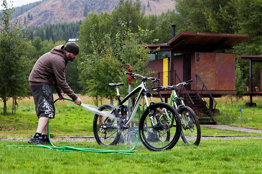Cleaning Photograph - Man Washes Two Mountain Bikes by Dan Barham
