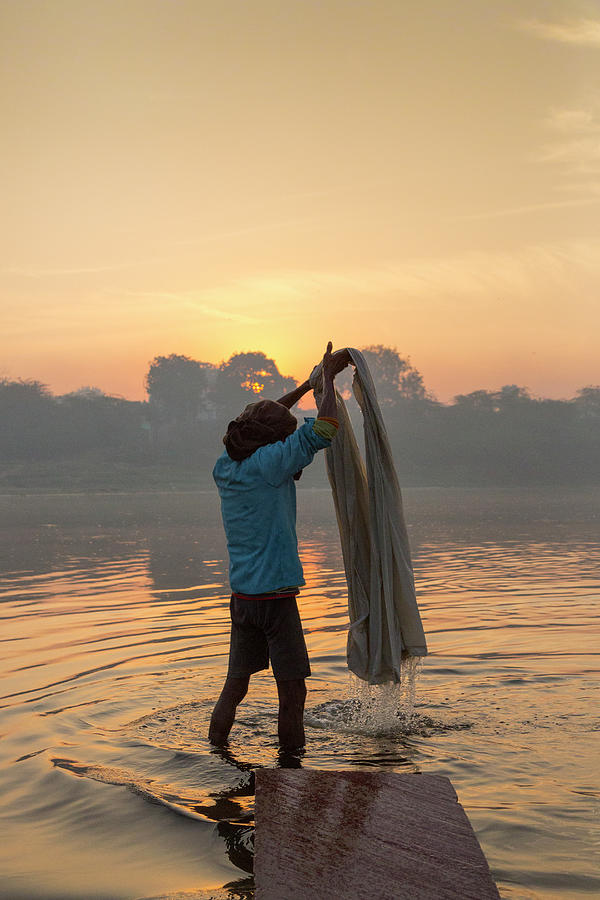 Man Washing Sheet In Yamuna River, Agra Photograph by Adrian Pope