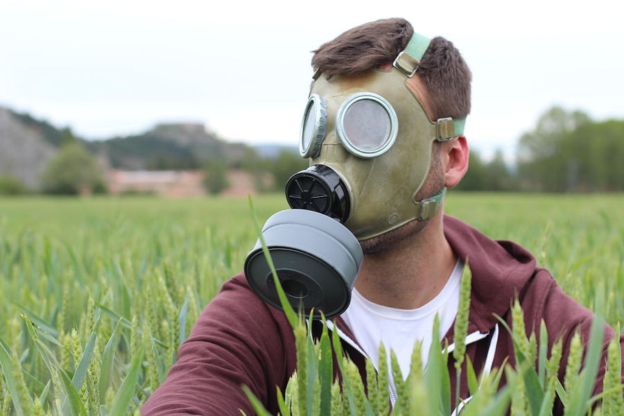 Man wearing breathing mask in wheat field Photograph by Ajr_images