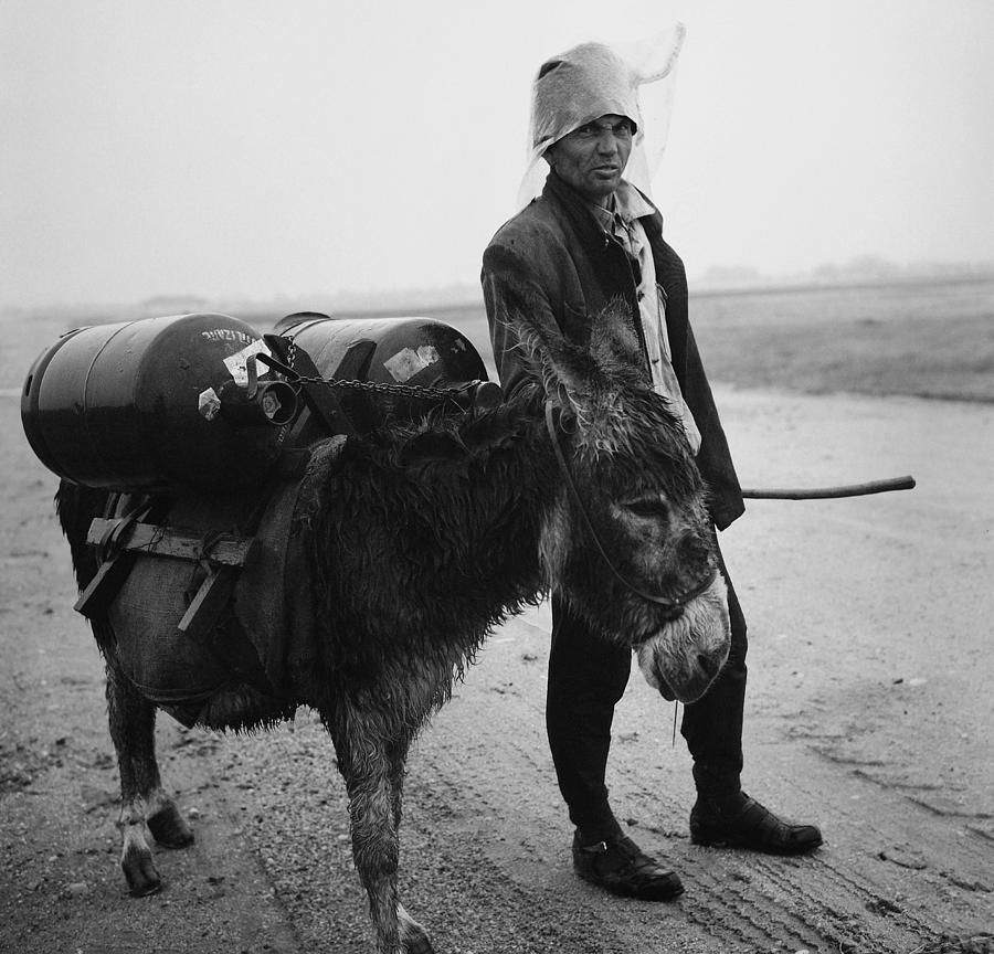 Man with donkey in communist Romania Photograph by Emanuel Tanjala