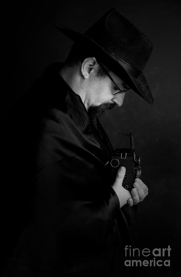 Man with glasses and black hat holding an old camera Photograph by Jaroslaw Blaminsky