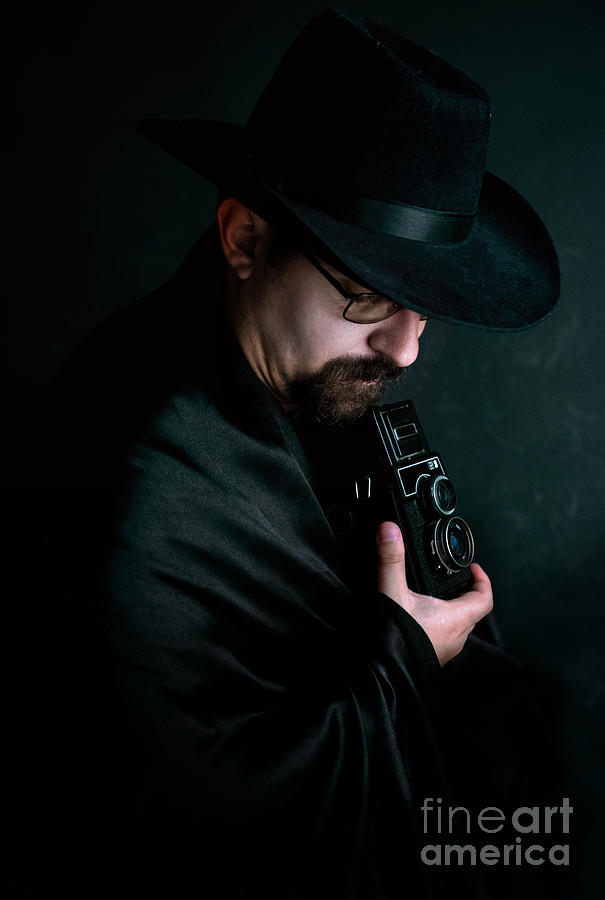 Man with goatee and black hat holding an old style camera Photograph by Jaroslaw Blaminsky