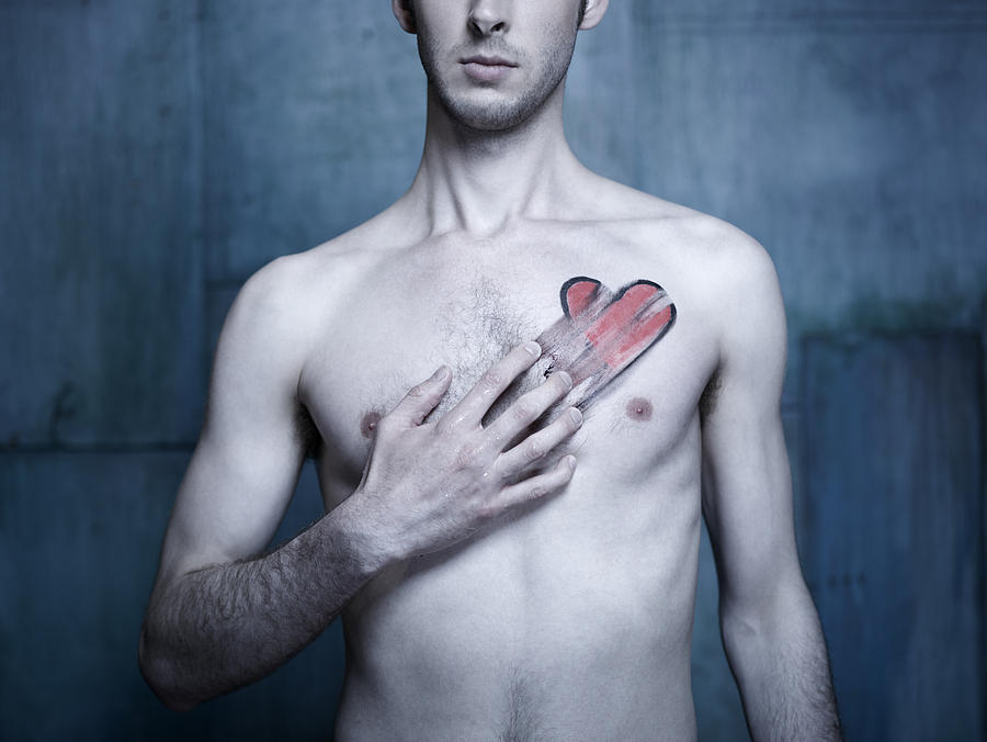 Man with red heart smeared across his chest Photograph by Nisian Hughes