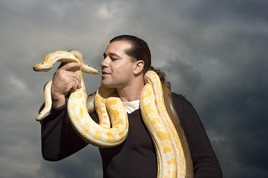 Man with snakes around neck Photograph by Thinkstock