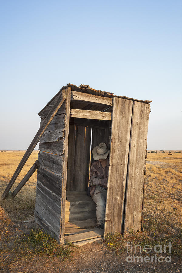 Mannequin sitting in old wooden outhouse Photograph by Bryan Mullennix