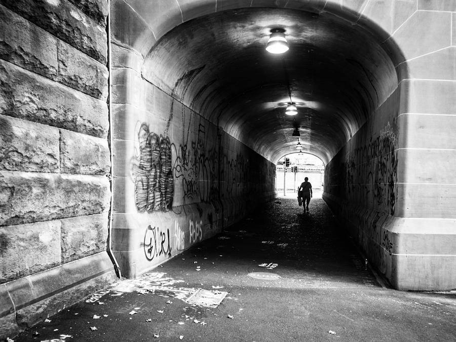 Black And White Photograph - Mans Silhouette in Urban Tunnel Black and White by Kaleidoscopik Photography